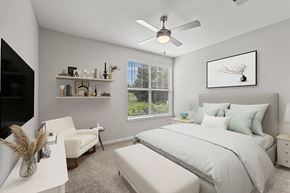 Murfreesboro apartment for rent - a bedroom with a large bed and a ceiling fan at Fortress Grove, Murfreesboro
