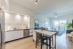 Miami Lakes apartment for rent - A modern kitchen with a dining table and chairs.