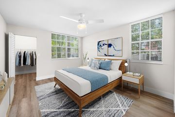Miami Lakes apartment for rent - A bedroom with a bed, nightstand, and a painting on the wall.