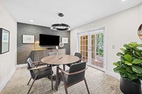 Miami Lakes apartment for rent - A modern dining room with a round table and chairs.