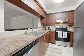 Miami Lakes apartment for rent - A kitchen with a granite counter top and stainless steel appliances.