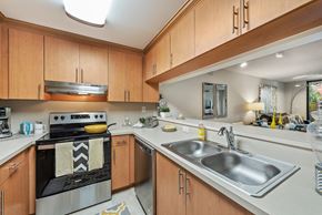 Miami Lakes apartment for rent - a kitchen with white counter tops and wooden cabinets