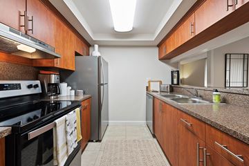 Miami Lakes apartment for rent - A kitchen with a black stove top oven and a black refrigerator.