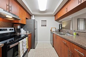 Miami Lakes apartment for rent - a kitchen with granite counter tops and a stainless steel refrigerator