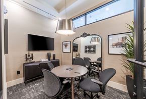 Miami Lakes apartment for rent - A conference room with a table, chairs, and a television.