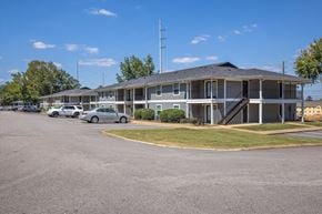 Auburn apartment for rent - A parking lot with cars and a building in the background.