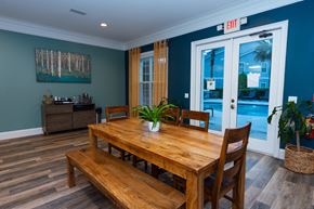Brunswick apartment for rent - a dining room with a wooden table and chairs     and a pool