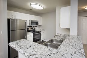 Perry apartment for rent - a kitchen with granite counter tops and stainless steel appliances