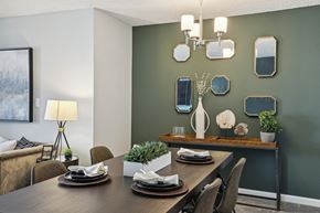 Arlington apartment for rent - a dining room with a table and chairs and a wall with mirrors