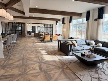 Huntersville apartment for rent - A spacious living room with a large patterned rug and a variety of seating options.