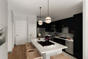 San Antonio apartment for rent - A modern kitchen with black cabinets and a white island.