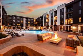 Lakewood apartment for rent - A pool with a fire pit in the middle of it.