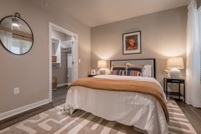 San Antonio apartment for rent - a bedroom with a bed and a door to a bathroom at The Can Plant Residences at Pearl, San Antonio, 78215