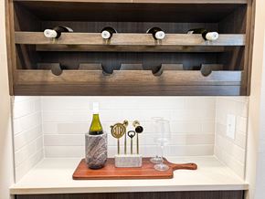 Spring Hill apartment for rent - A wooden wine rack with a bottle of wine and glasses on a tray.