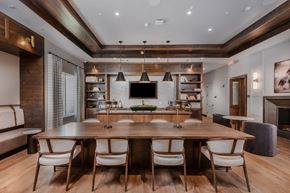 Spring Hill apartment for rent - A modern dining room with a large wooden table and chairs.