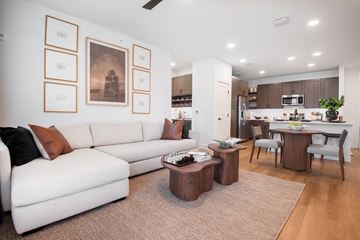 Spring Hill apartment for rent - A modern living room with a white couch and brown coffee table.