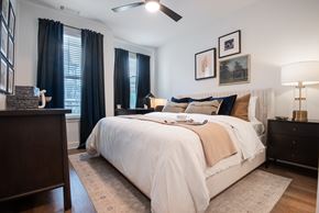 Spring Hill apartment for rent - A bedroom with a large bed and a ceiling fan.