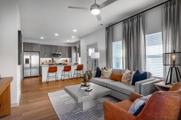 Fort Worth townhouse for rent - A modern living room with a grey couch and a grey coffee table.