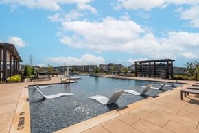 Schertz townhouse for rent - A large outdoor pool with a waterfall feature.
