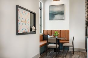 Schertz townhouse for rent - A dining area with a table set for two and a framed picture on the wall.