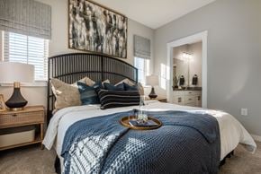 Boerne townhouse for rent - A bedroom with a large bed and a painting on the wall.