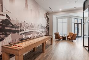 Charlotte apartment for rent - A room with a pool table and a wall mural of a bridge.