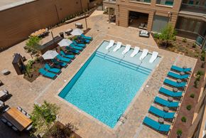 Charlotte apartment for rent - A large swimming pool surrounded by sun loungers.