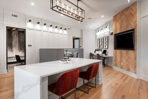 Huntersville apartment for rent - A modern dining room with a white table and red chairs.