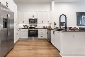 Huntersville apartment for rent - A modern kitchen with white cabinets and stainless steel appliances.