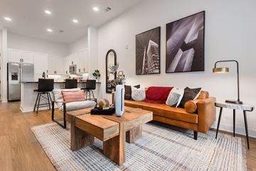 Huntersville apartment for rent - A modern living room with a wooden coffee table and a couch.