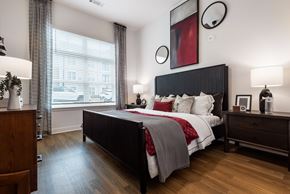Huntersville apartment for rent - A bedroom with a large bed and a wooden dresser.