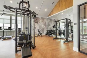 Fort Worth townhouse for rent - A gym with a variety of equipment including treadmills, weights, and machines.