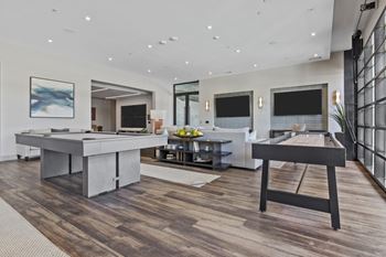 Private clubroom with shuffleboard, fireplace, and tv