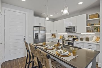 San Antonio apartment for rent - A modern kitchen with a dining table set for two.