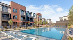 Lewisville apartment for rent - A swimming pool in front of apartment buildings.