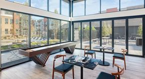 Lewisville apartment for rent - A modern dining room with a glass table and chairs.