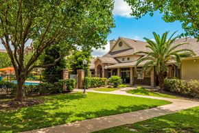Houston apartment for rent - the front of a house with a yard and a swimming pool