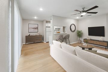 Austin apartment for rent - A modern living room with a white sofa and a wooden floor.