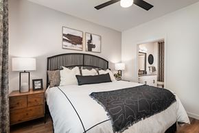Goodyear apartment for rent - A bedroom with a large bed and a ceiling fan.