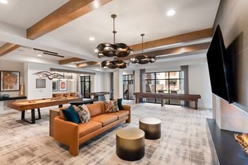 Phoenix apartment for rent - A modern living room with a brown sofa and a television on the right side.