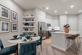 Phoenix apartment for rent - A modern kitchen with a dining table set for two.