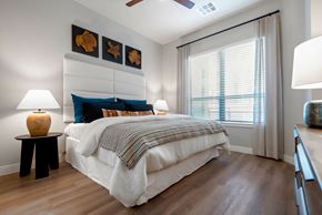Phoenix apartment for rent - A bedroom with a large bed and a ceiling fan.