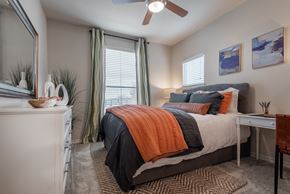 San Antonio apartment for rent - an open bedroom with a bed and a ceiling fan
