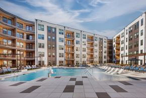 Charlotte apartment for rent - A large swimming pool in front of apartment buildings.