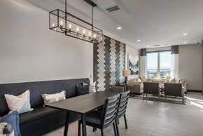 Denver apartment for rent - A modern dining room with a dark grey sofa and a wooden table.