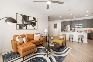Denver apartment for rent - A living room with a brown sofa and a painting on the wall.