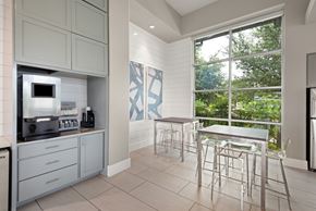 Kyle apartment for rent - a kitchen with a table and chairs next to a window