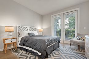 Kyle apartment for rent - a bedroom with a bed and a chair