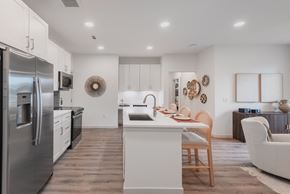 Littleton apartment for rent - A modern kitchen with a stainless steel refrigerator and wooden flooring.