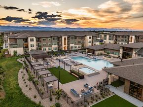 Littleton apartment for rent - A sunset view of a resort with a pool and a patio.